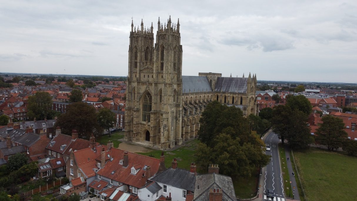 Aerial view of Canterbury Cathedral surrounded by residential rooftops.